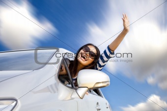 happy young woman in car driving on the road