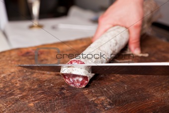 Butcher Slicing Salami