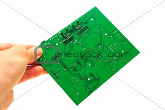 Human hand holding green computer circuit board