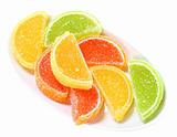 Group of sweets as citrus fruits on white plate