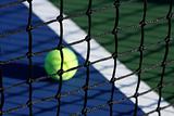 Tennis Court Net with Ball in Background