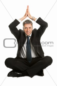 Businessman sitting in lotus flower position of yoga