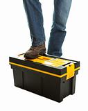 Close-up of repairman standing on toolbox