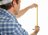 Confident worker using tape to measure dimensions