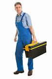 Confident service man standing with toolbox