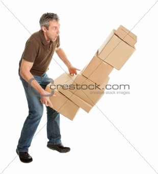 Delivery man with falling stack of boxes