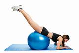 Young woman doing roll-out on the fitness ball
