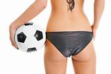 Beautilful woman in bikini posing with soccer ball