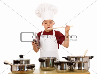 Boy in chef hat playing