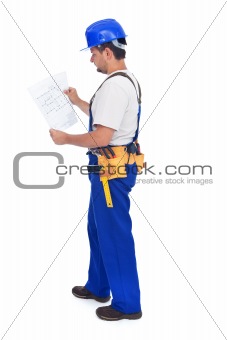 Handyman or construction worker checking the blueprints