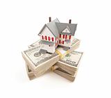 Small House on Stacks of Hundred Dollar Bills Isolated on a White Background.