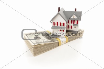 Small House on Stack of Hundred Dollar Bills Isolated on a White Background.