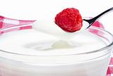 raspberry on a spoon with yogurt