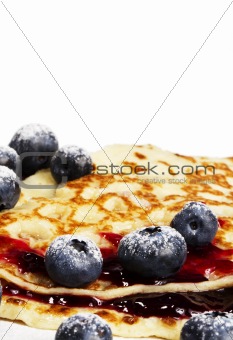 sugar covered blueberries on pancakes with jam