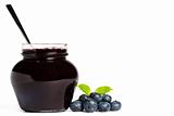 jam jar with blueberry jam a spoon and blueberries with a leaf melissa
