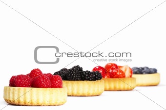 raspberries in tartlet cake in front of others