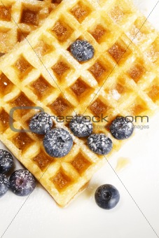 waffles with sugar covered blueberries from top