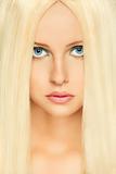 Portrait of blond hair woman with blue eyes. Retouched
