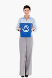 Businesswoman showing a recycling bin