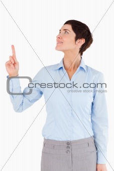 Portrait of a woman pointing at copy space