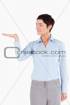 Businesswoman with an open hand to show a copy space