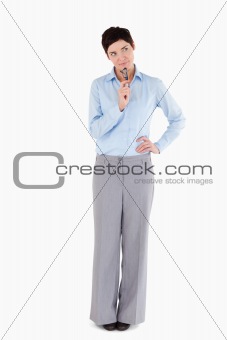 Doubtful businesswoman holding her glasses