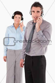 Portrait of office workers using headsets