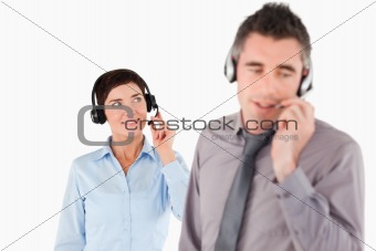 Business people speaking through headsets