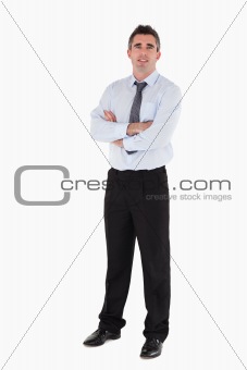Businessman standing up with his arms crossed