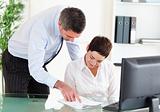 Business manager showing something on a document to his secretary