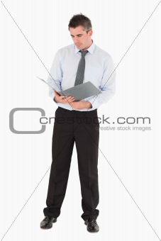 Businessman looking at a binder