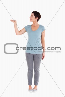 Dark-haired woman showing a copy space