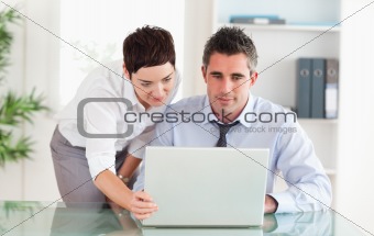 Coworkers using a laptop