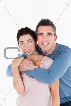 Portrait of a man embracing his wife