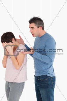 Woman crying while her husband is trying to explain himself