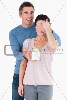 Portrait of a man surprising his wife with a present