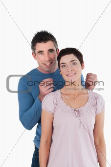 Handsome man offering a necklace to his wife