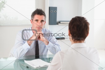 Serious manager interviewing a female applicant
