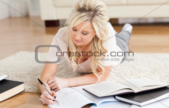 Blond College Student lying on the floor learning