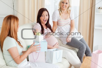 Laughing Friends having a baby-party