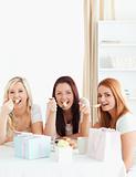 Cheerful Women sitting at a table eating a cake