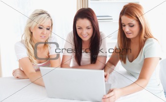 Women sitting at a table with a laptop