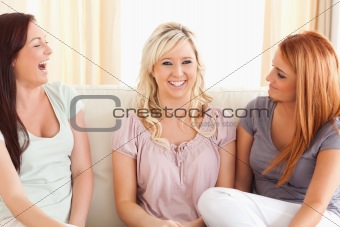 Cheering women sitting on a sofa