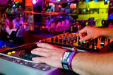 Dj mixes the track in the nightclub at a party