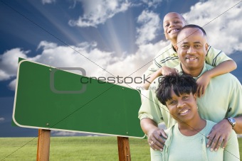 Attractive African American Family in Front of Blank Green Road Sign Ready for Your Own Message.