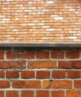 close view of a brick wall with another brick wall in the distan
