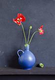blue vase and poppy blossoms