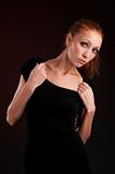 young redhead woman in black dress