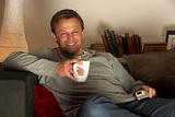 Man Relaxing With Coffee And Television