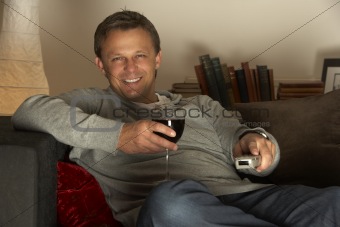 Man With Glass Of Wine Watching Television